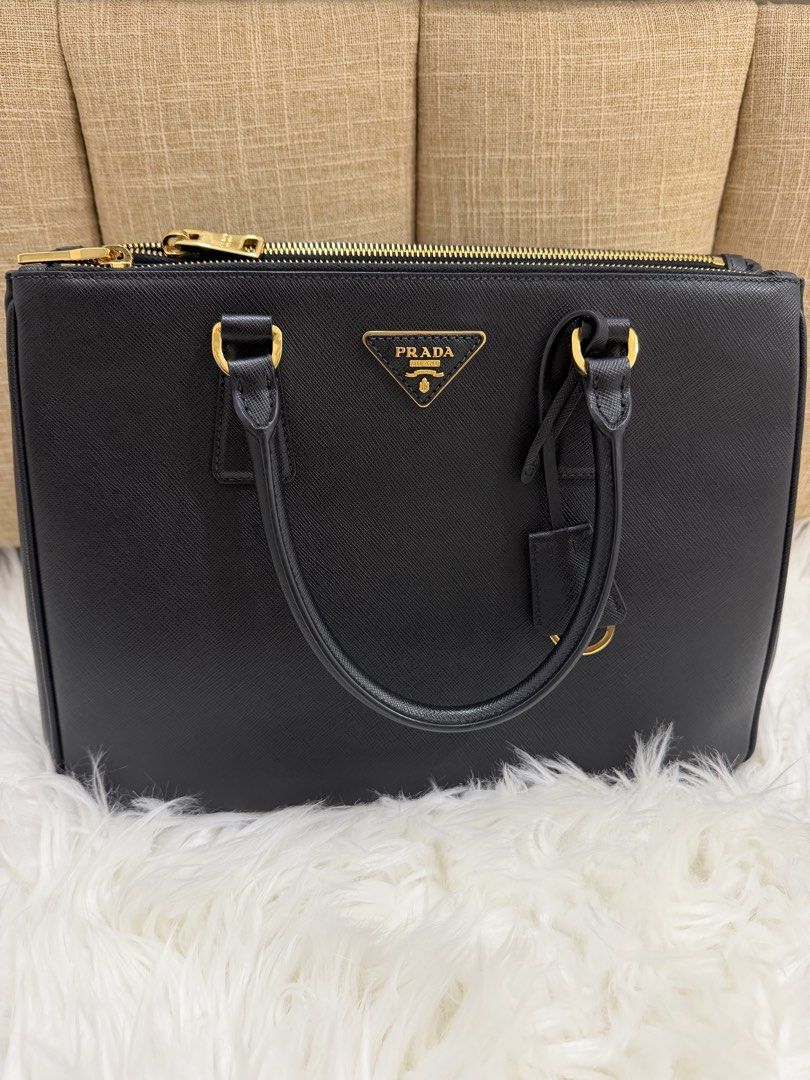 Prada Saffiano Galleria (Category: Luxury Bags & Wallets) located in Quezon City. Submitted by 9ashcervantes_ (Listing ID 1456705516, Image 1). Description: - Classic black Prada Large with ENTRUPY - Genuine Saffiano leather - Gold hardware - Top zip closure - Detachable shoulder strap included - Spacious interior - Ideal for work or everyday use - Authenticity guaranteed.