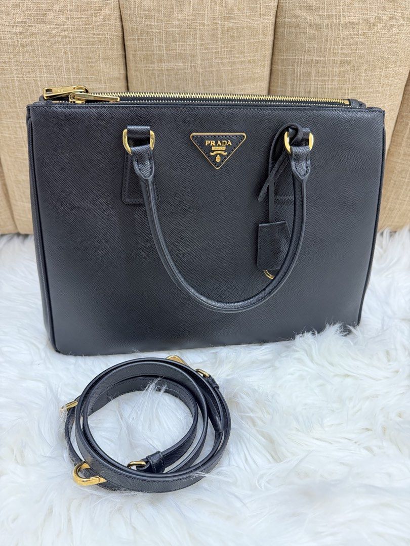 Prada Saffiano Galleria (Category: Luxury Bags & Wallets) located in Quezon City. Submitted by 9ashcervantes_ (Listing ID 1456705516, Image 2). Description: - Classic black Prada Large with ENTRUPY - Genuine Saffiano leather - Gold hardware - Top zip closure - Detachable shoulder strap included - Spacious interior - Ideal for work or everyday use - Authenticity guaranteed.