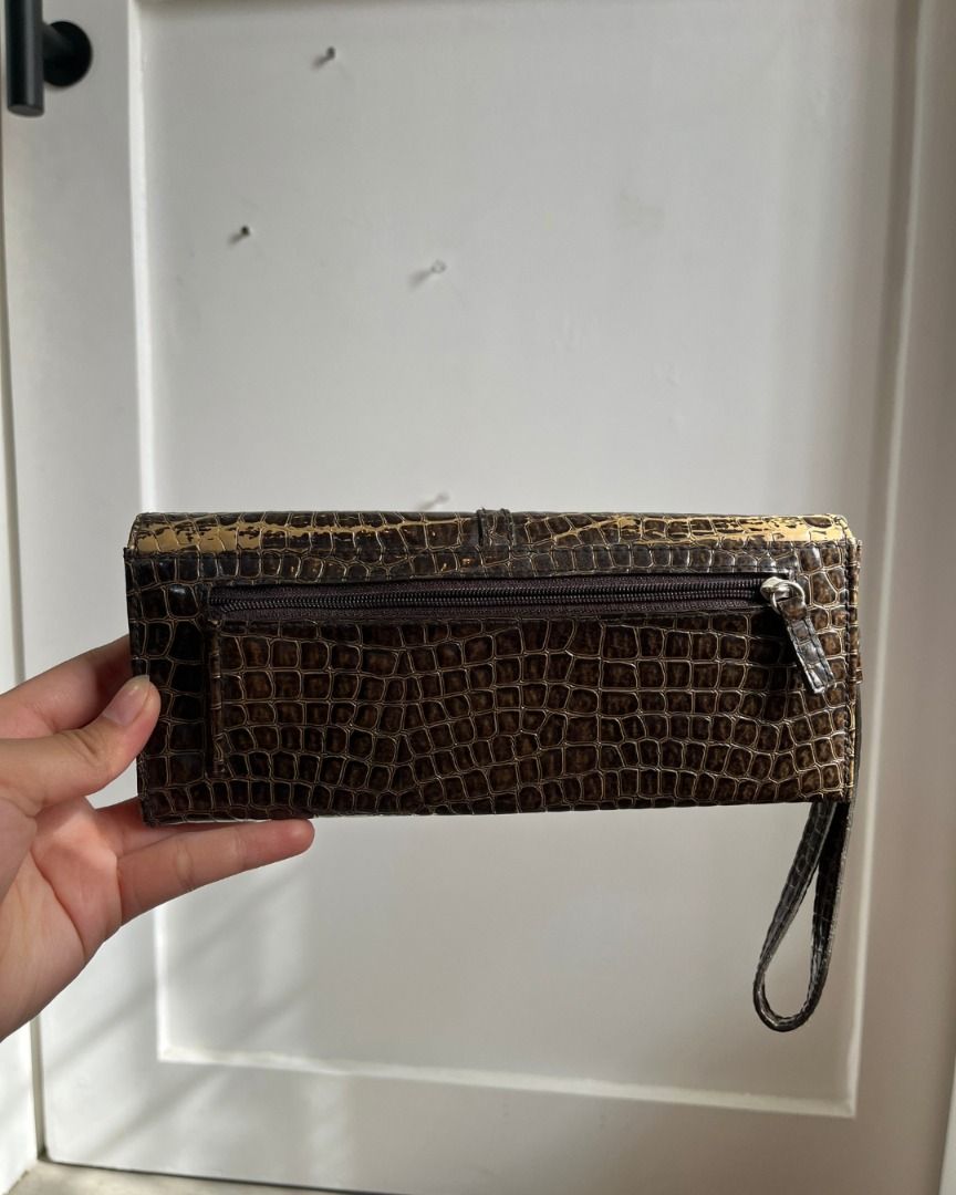 Pre-loved Brown Faux Croc Wallet (Category: Luxury Bags & Wallets) located in Taguig. Submitted by emgoofficial (Listing ID 1456647079, Image 2). Description: Stylish faux crocodile leather wallet bought in the USA. Wallet has a wristlet strap with a detachable card holder and coin purse, plus plenty of space for cash bills. 📌 Pre-loved condition with slight signs of wear and minor stitch damage inside 💬 Price negotiable! 📍 Taguig • PAYO or 3-