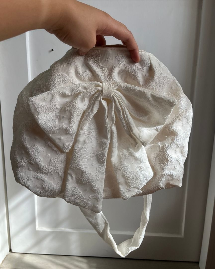 Pre-loved Coquette Bow Crossbody Bag (Category: Cross-body Bags) located in Taguig. Submitted by emgoofficial (Listing ID 1456632455, Image 3). Description: Super cute coquette style bag perfect for on-the-go. Made of textured cloth with a big front ribbon design and a convenient magnetic closure. 📌 Pre-loved condition with gentle signs of use. 💬 Price negotiable! 📍 Taguig • PAYO or 3-day DOP (flexible upon discussion) • J&T / Lalamove / Angka