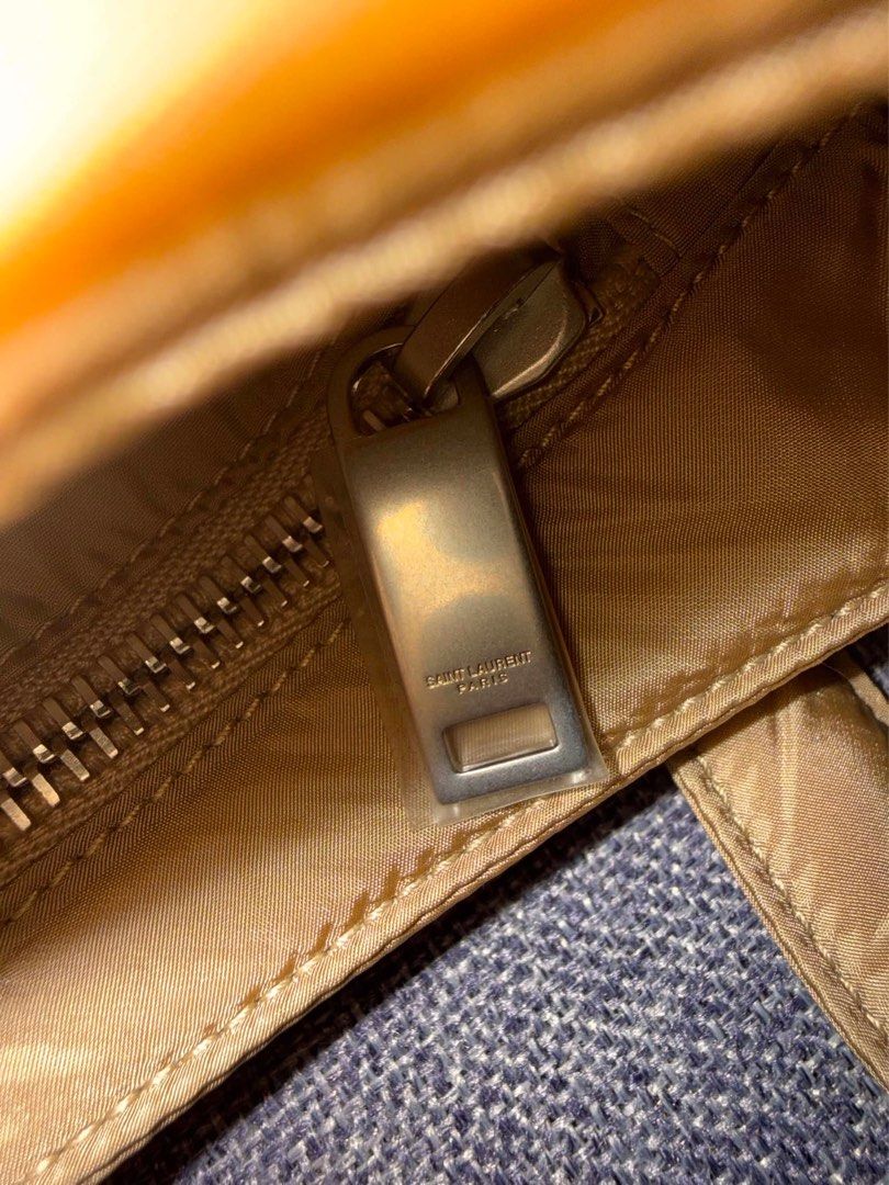 Saint Laurent Paris Nylon Shoulder Bag (Category: Luxury Bags & Wallets) located in Paranaque City. Submitted by piasacramento (Listing ID 1456633648, Image 3). Description: - Authentic Saint Laurent Paris shoulder bag - Tan nylon material with yellow trim - Iconic white YSL logo - Interior zip pocket - Leather patch with Saint Laurent Paris branding - Engraved Saint Laurent Paris zipper pull - Comes with dust bag and authenticity cards.