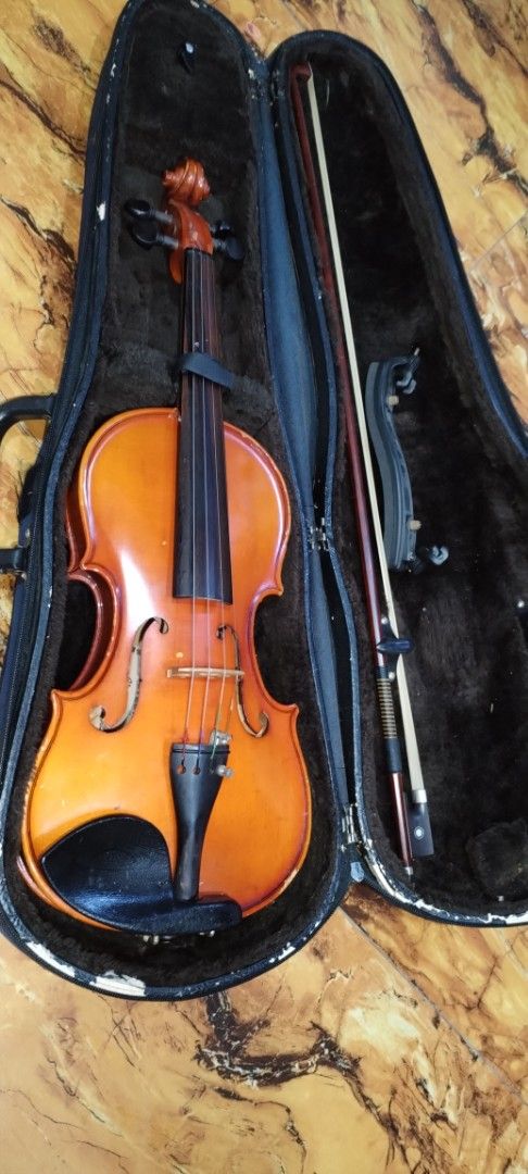 Shim's Korea Tech Violin with Case and Bow (Category: Musical Instruments) located in Caloocan City. Submitted by rowely_jpn (Listing ID 1456630865, Image 2). Description: Selling a Shim's Korea Tech violin. Comes with a case and a bow. The violin has a nice orange-brown finish. The case is dark blue and has some wear and tear, particularly on one corner. Great for beginners or intermediate players. Ready for a new home..