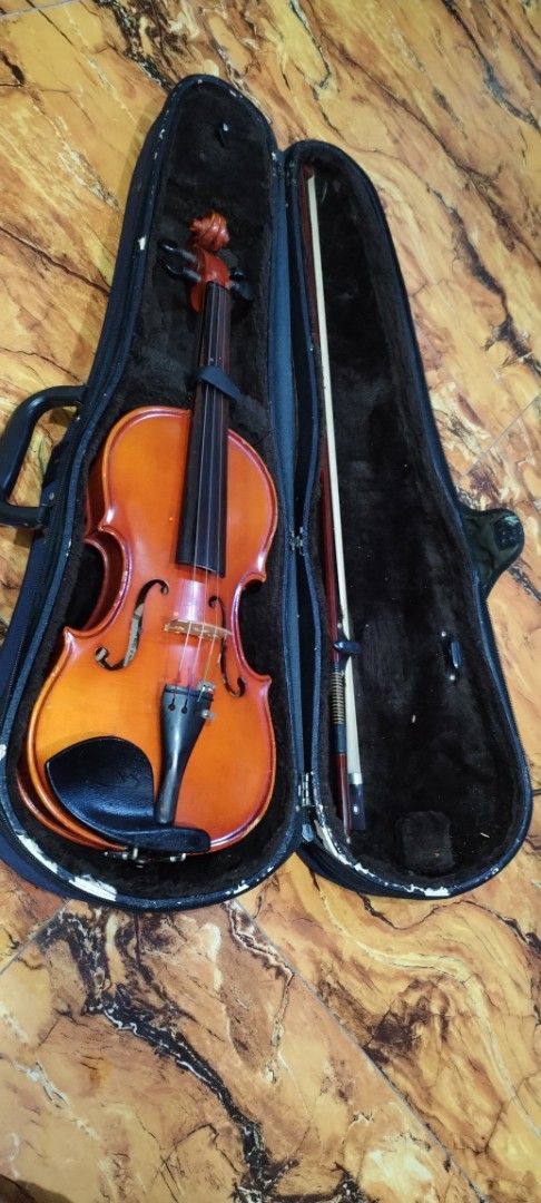 Shim's Korea Tech Violin with Case and Bow (Category: Musical Instruments) located in Caloocan City. Submitted by rowely_jpn (Listing ID 1456630865, Image 1). Description: Selling a Shim's Korea Tech violin. Comes with a case and a bow. The violin has a nice orange-brown finish. The case is dark blue and has some wear and tear, particularly on one corner. Great for beginners or intermediate players. Ready for a new home..