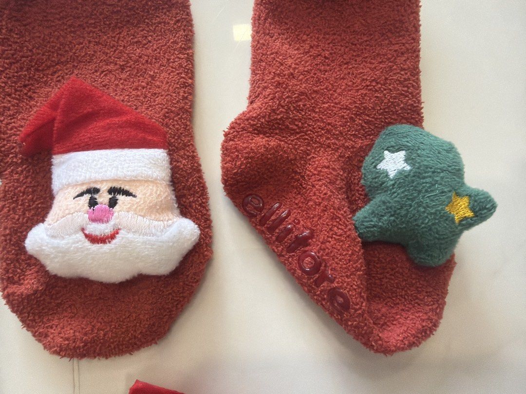 Socks (Category: Babies & Kids Fashion) located in Singapore. Submitted by pauline9287 (Listing ID 1456662521, Image 3). Description: - Set of three pairs of kids' socks ($7 for 3pairs) - Grey fuzzy socks with car wheel design and 'KIDS SOCKS' text. - Red fuzzy socks featuring Santa Claus and Christmas tree appliques. - Black ankle socks with red devil wing details and 'KIDO HOUSE' branding. - Suitable for both boys and girls..