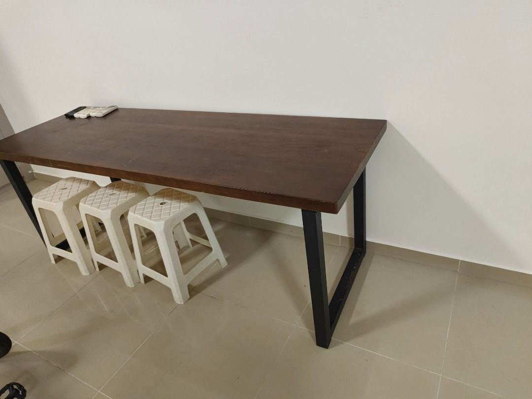 Solid wood dining table study table (Category: Tables & Sets) located in Singapore. Submitted by vvbeautystore (Listing ID 1456631201, Image 2). Description: Used but in good condition. Solid wood table top. Very sturdy. Easy to dismantle and transport. Two sets available. 200x80x75H @ $60 200x70x75H @ $50 Self collect at woodlands area.