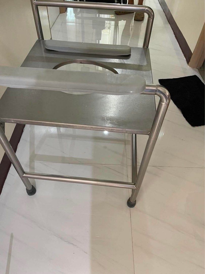 Stainless Steel Commode Chair with Armrests (Category: Medical Supplies & Tools) located in Mandaluyong City. Submitted by user4759642 (Listing ID 1456715195, Image 2). Description: - Durable stainless steel construction - Built-in armrests for enhanced support - Spacious seat opening for comfort - Sturdy metal frame with non-slip rubber leg stoppers - Excellent for individuals needing mobility assistance - Height from floor to knee 19 inch - wid
