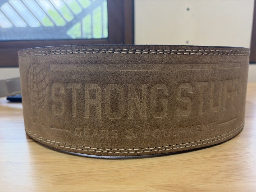 Strong Stuff Weightlifting Belt with Lever Buckle (Category: Weights & Dumbbells) located in Cainta. Submitted by lancearizo12894 (Listing ID 1456650960, Image 1). Description: - Strong Stuff Weightlifting Belt - Features a secure lever buckle - Durable suede exterior with reinforced stitching - Provides excellent core support for heavy lifts - Ideal for your next training session -Premium lever belt 10mm - Size small for people with waist 26”-35