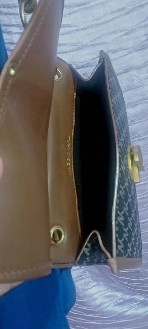 Structured Leather Shoulder Bag with Brown Trim, sling bag (Category: Shoulder Bags) located in Taytay. Submitted by ForQueens (Listing ID 1456774983, Image 3). Description: - Adorable shoulder bag with a classic monogram pattern. - Features stylish brown trim and elegant gold hardware. - Adjustable strap with convenient knots for a custom fit. - Includes a handy small compartment inside for organization. - A versatile accessory that complements 