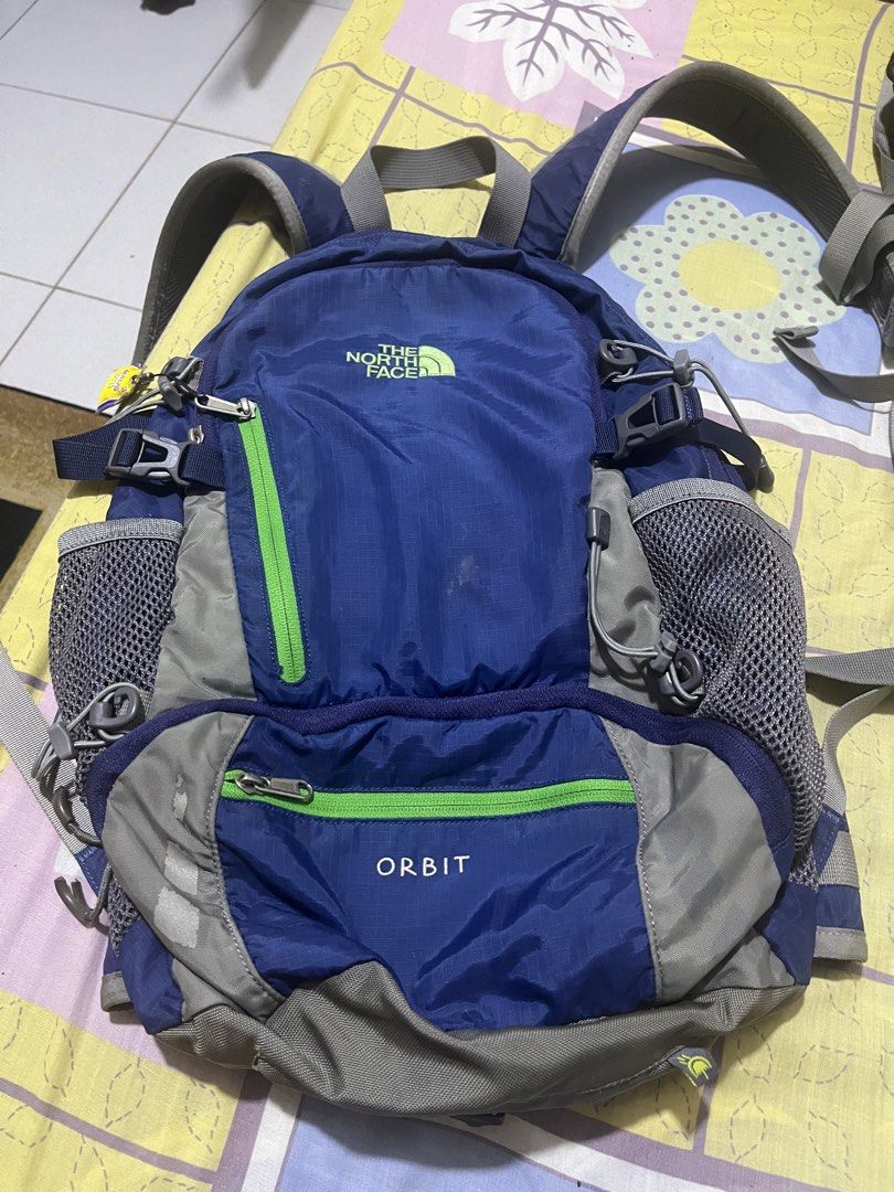 The North Face Orbit Backpack Blue Green (Category: Backpacks) located in Manila. Submitted by jankbaiteh05162 (Listing ID 1456627466, Image 3). Description: - Brand: The North Face - Model: Orbit - Color: Blue with green accents - Features: Multiple pockets, mesh side pockets - Includes: Blue rain cover with The North Face logo - Ideal for: Day trips, hiking.