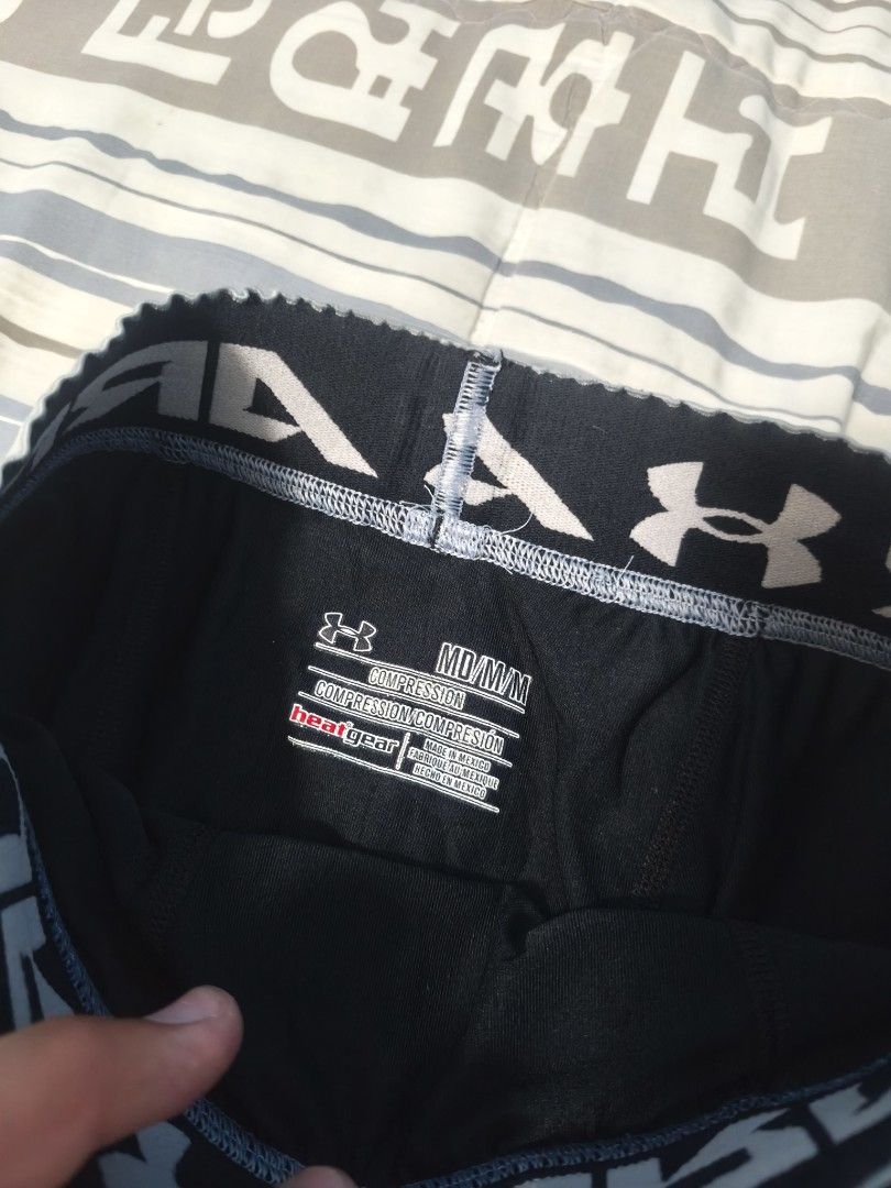 Under Armour Black Compression Shorts Men (Category: Activewear) located in Banate. Submitted by StGoodies (Listing ID 1456638944, Image 3). Description: - Brand: Under Armour - Type: Compression Shorts - Color: Black - Logo: Grey Under Armour logo on left leg - Waistband: Elastic with Under Armour branding - Size: Medium - Ideal for: Workouts, sports, athletic activities.