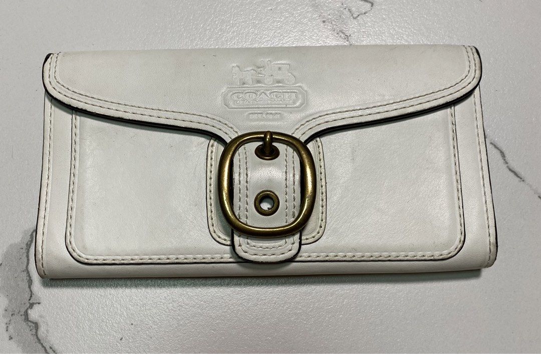 Vintage Coach White Bleecker Leather Trifold (Category: Luxury Bags & Wallets) located in Balagtas. Submitted by dadalalashop (Listing ID 1456614694, Image 1). Description: The white leather Coach Bleeker wallet features a distinctive brass buckle closure and an embossed logo on the front flap..