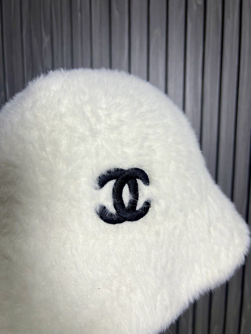 White Fuzzy Bucket Hat with Black CC Logo (Category: Hats & Beanies) located in Baguio. Submitted by chiechie1234 (Listing ID 1456690311, Image 2). Description: - Super soft and fuzzy white bucket hat - Features iconic black CC logo embroidered on the front - Provides sun protection while keeping you stylish - Ideal for casual outings or adding flair to any outfit - One size fits most.