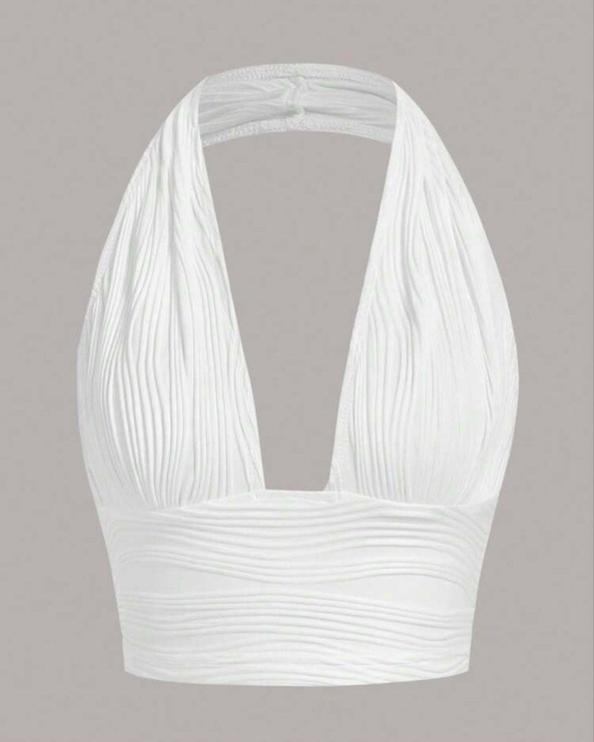 White Plunging Halter Neck Cropped Top (Category: Sleeveless) located in Manila. Submitted by itsandreaco (Listing ID 1456688704, Image 1). Description: - Measurements: Bust 33-36 inches - White halter neck crop top - Textured fabric - Deep plunge neckline - Stretchy material .