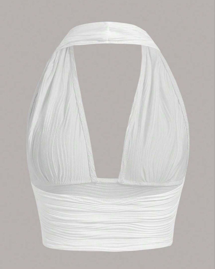 White Plunging Halter Neck Cropped Top (Category: Sleeveless) located in Manila. Submitted by itsandreaco (Listing ID 1456688704, Image 2). Description: - Measurements: Bust 33-36 inches - White halter neck crop top - Textured fabric - Deep plunge neckline - Stretchy material .