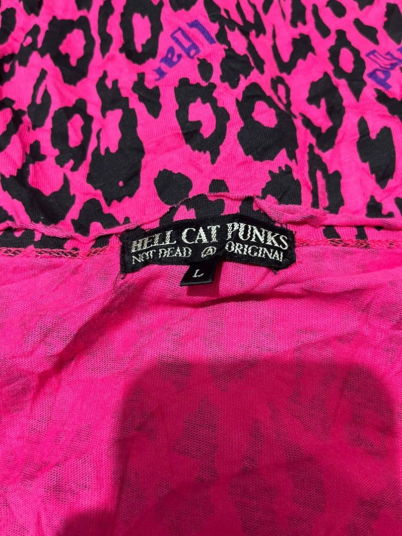Y2K Hell Cat Punks Long Sleeves (Category: Longsleeves) located in Zamboanga. Submitted by archivist_ (Listing ID 1456738864, Image 2). Description: - Y2K Hell Cat Punks long-sleeved top - Vibrant hot pink and black leopard print - Features 'Hell Cat Punks - Not Dead @ Original' branding - Size: Large (L) - Lightweight and comfortable fabric - Perfect for a retro, edgy style.