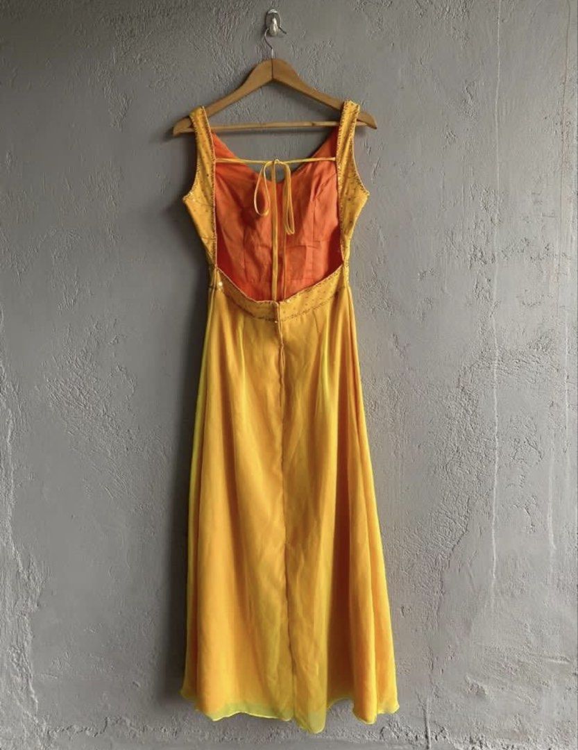 Yellow Gown with Beaded Waist and Open Back (Category: Evening dresses & gowns) located in Binan City. Submitted by forgetmenot_ph (Listing ID 1456671637, Image 2). Description: - Flowy yellow gown - Flattering V-neckline with ruched detailing - Elegant beaded embellishment at the waist - Chic open back with adjustable tie closure - Contrasting orange lining for a pop of color - Sheer overlay on the hemline for added flair - Ideal for special eve