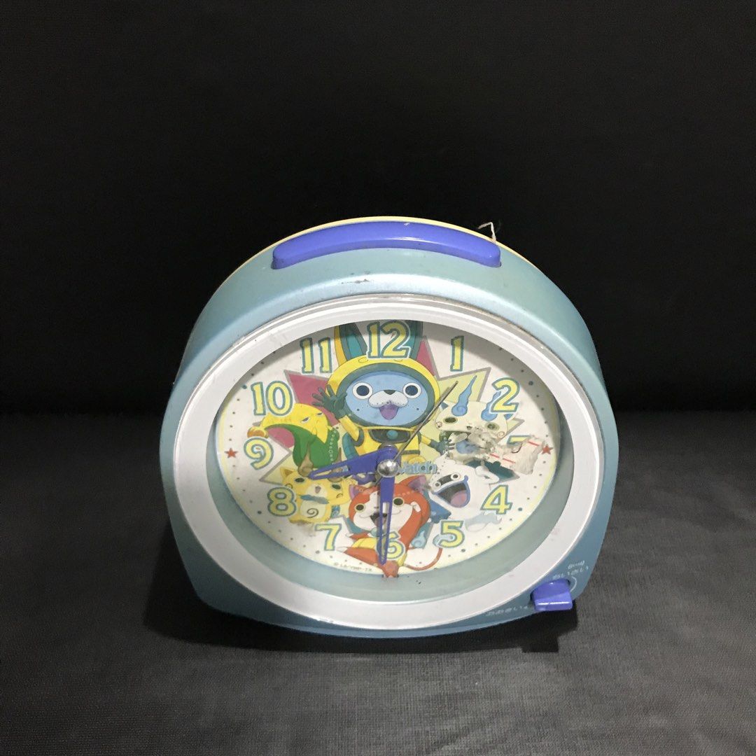 Yo-kai Alarm Clock (Category: Clocks) located in Baao. Submitted by all.things.japan (Listing ID 1456672714, Image 2). Description: - Cute Yo-kai Watch alarm clock - Features characters from the show - Light blue and yellow casing - Alarm on/off switch and snooze button - Battery operated - Perfect for fans or a fun bedside clock.