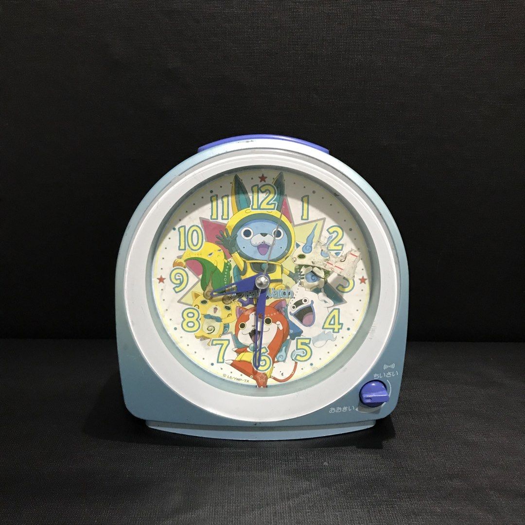 Yo-kai Alarm Clock (Category: Clocks) located in Baao. Submitted by all.things.japan (Listing ID 1456672714, Image 1). Description: - Cute Yo-kai Watch alarm clock - Features characters from the show - Light blue and yellow casing - Alarm on/off switch and snooze button - Battery operated - Perfect for fans or a fun bedside clock.