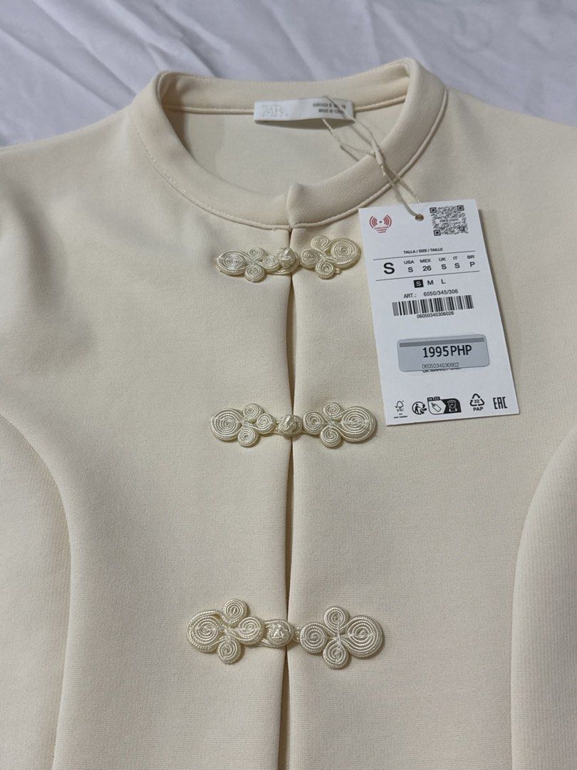 Zara Stretch Top with Frog Fastenings (Category: Blouses) located in Masbate. Submitted by anjcbr (Listing ID 1456604316, Image 2). Description: - Zara Stretch Top with Frog Fastenings - Mandarin collar with traditional frog button closures - Brand new with tag still attached.
