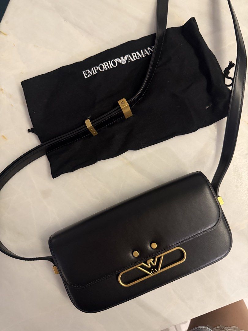 Authentic Armani Black Leather Shoulder Bag with Gold Hardware (Category: Luxury Bags & Wallets) located in Taguig. Submitted by claire08hyun (Listing ID 1456912669, Image 1). Description: - Authentic Emporio Armani black leather shoulder bag - Features elegant gold hardware - Iconic Emporio Armani eagle logo detail - Comes with original dust bag for protection - Expertly crafted in Italy - Milano 1981 branding on the back - Interior is clean and