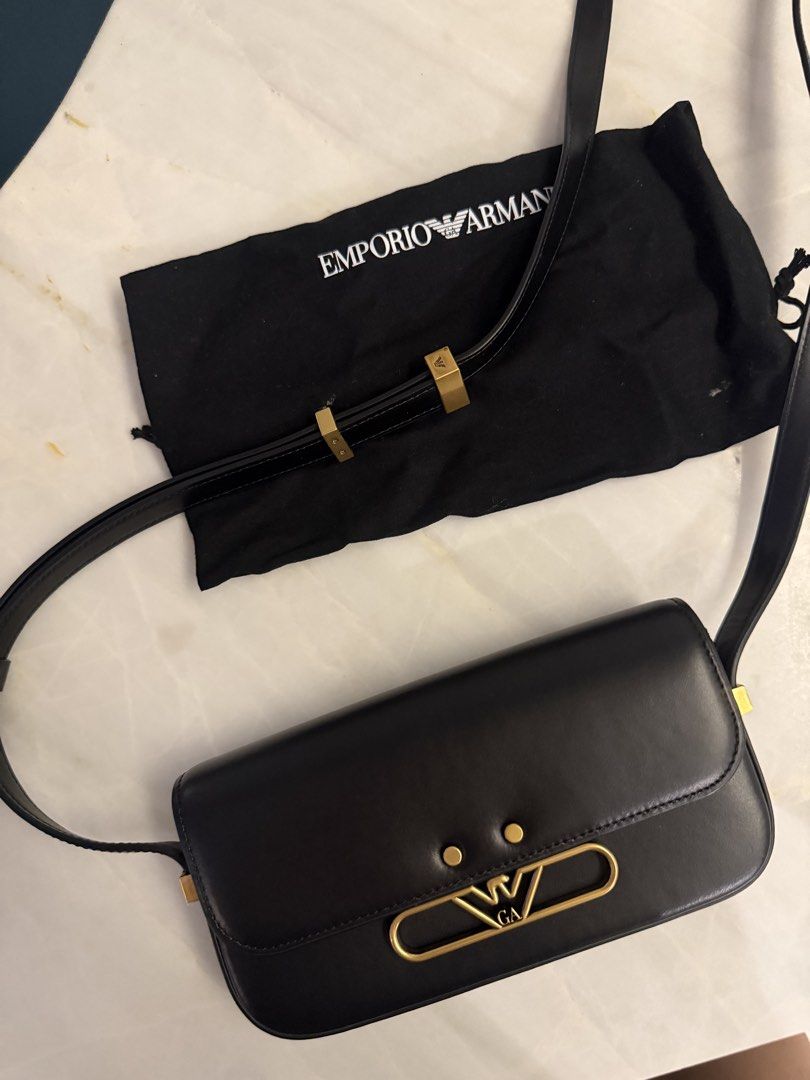 Authentic Armani Black Leather Shoulder Bag with Gold Hardware (Category: Luxury Bags & Wallets) located in Taguig. Submitted by claire08hyun (Listing ID 1456912669, Image 2). Description: - Authentic Emporio Armani black leather shoulder bag - Features elegant gold hardware - Iconic Emporio Armani eagle logo detail - Comes with original dust bag for protection - Expertly crafted in Italy - Milano 1981 branding on the back - Interior is clean and