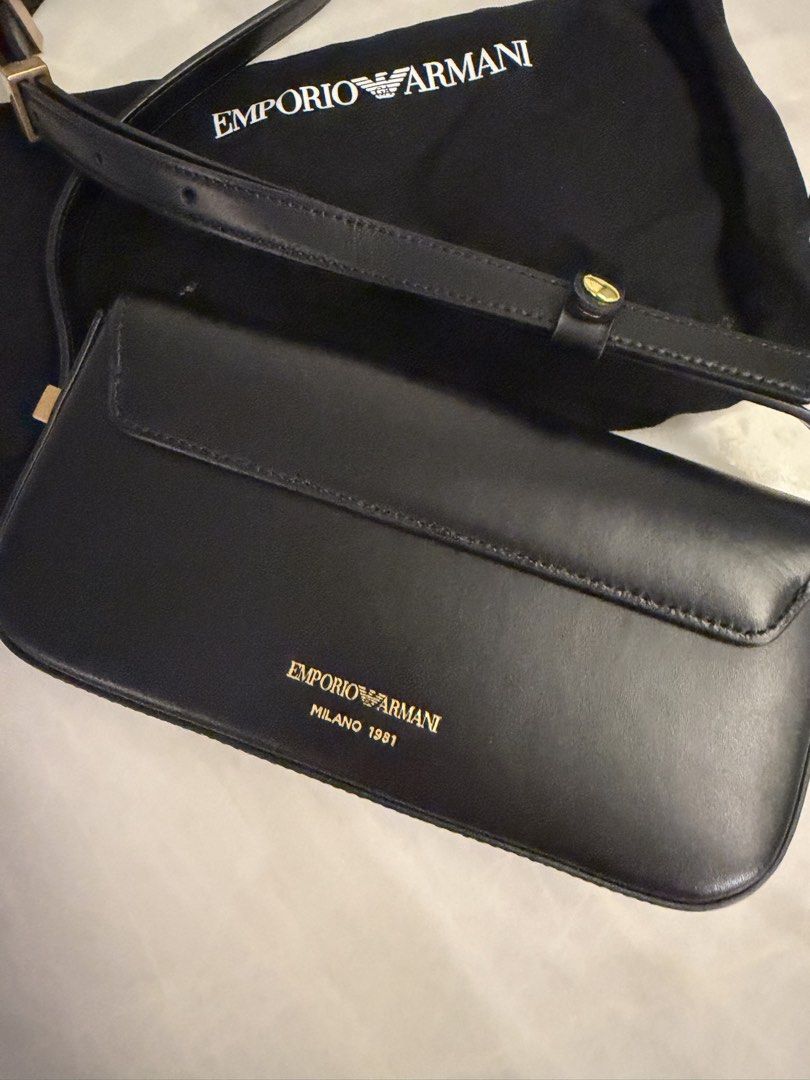 Authentic Armani Black Leather Shoulder Bag with Gold Hardware (Category: Luxury Bags & Wallets) located in Taguig. Submitted by claire08hyun (Listing ID 1456912669, Image 3). Description: - Authentic Emporio Armani black leather shoulder bag - Features elegant gold hardware - Iconic Emporio Armani eagle logo detail - Comes with original dust bag for protection - Expertly crafted in Italy - Milano 1981 branding on the back - Interior is clean and