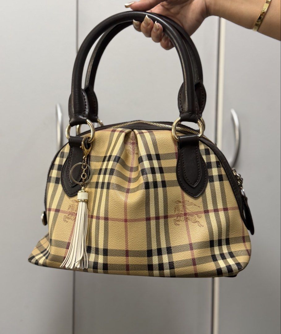 Authentic Burberry Haymarket Handbag (Category: Luxury Bags & Wallets) located in Pasay City. Submitted by xwhatsinmycloset (Listing ID 1456822369, Image 2). Description: FOR SALE OR SWAP Authentic Burberry Haymarket Handbag Good pre-owned condition with signs of normal use; minor leather fading/wear on handles. Zippers and hardware are fully functional.