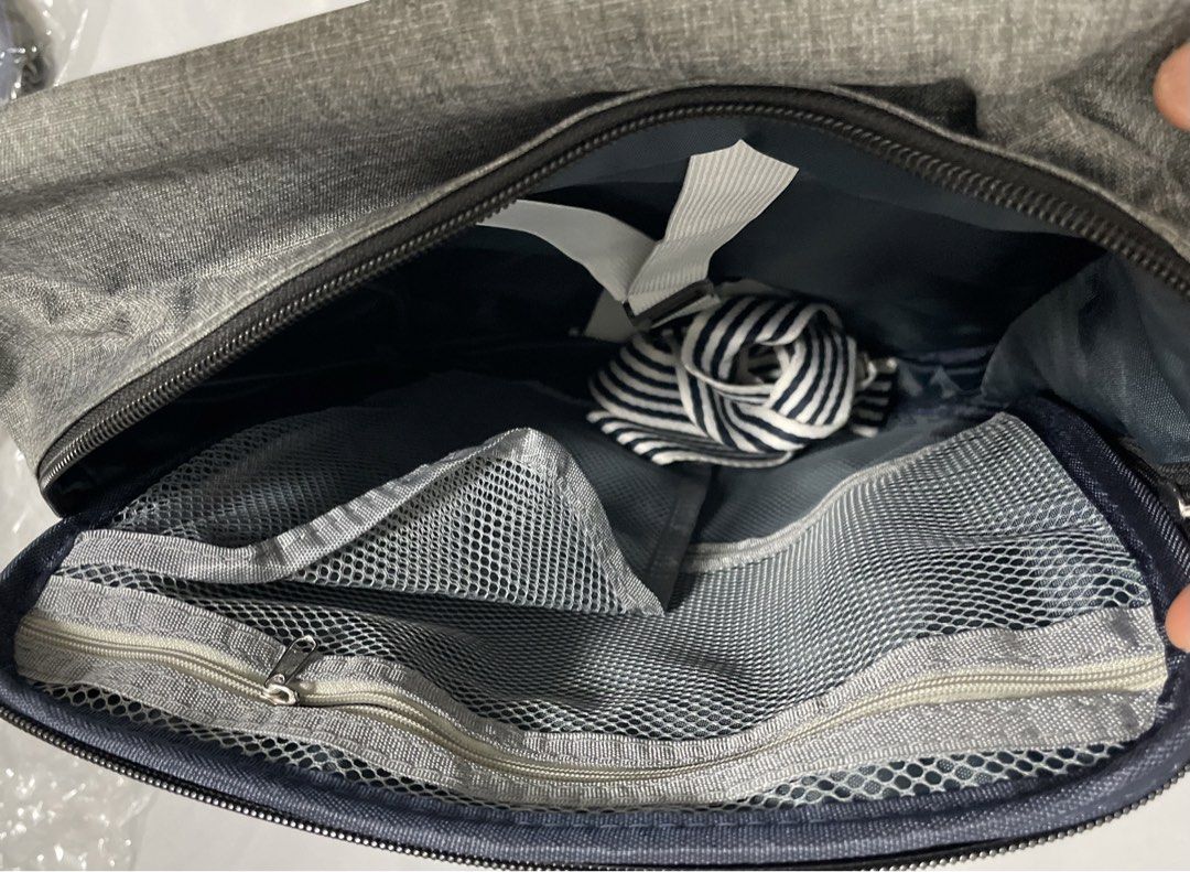 Backpack (Category: Laptop Bags & Sleeves) located in Singapore. Submitted by johnalba15 (Listing ID 1456901486, Image 3). Description: - Backpack with strips - Main zippered compartment - Front zippered pocket - Internal mesh pockets for organization - Exterior D-rings - Striped fabric accents - Ideal for storing essentials while traveling.