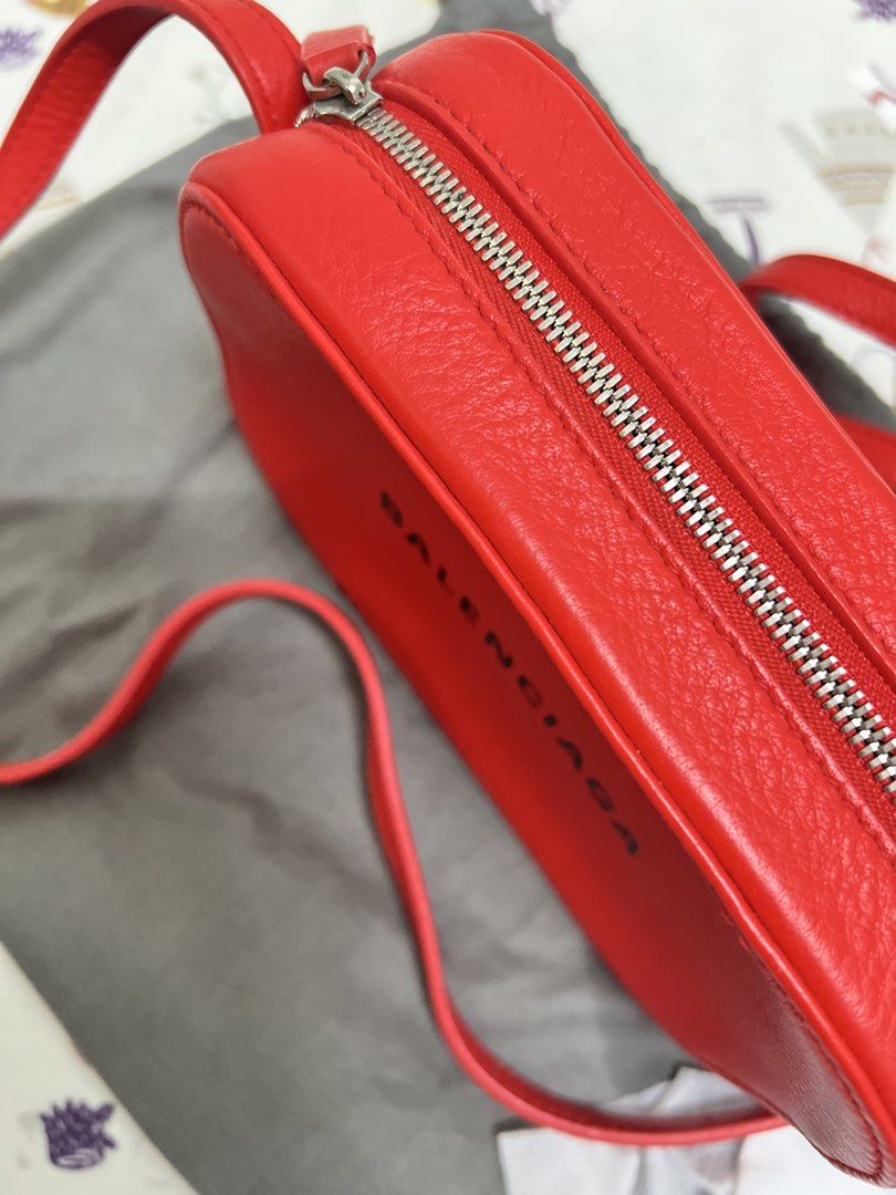 Balenciaga Camera Bag Red (Category: Luxury Bags & Wallets) located in Malolos. Submitted by nutellahxx (Listing ID 1456816436, Image 2). Description: STILL LOOKING FOR THE CARD. I MISPLACED IT. Bought it in US. 100% Authentic. You can check it thoroughly pag meet up or even get it tested. Thanks! Can do swap to Ipad Pro M4 and up. I can add cash Location: The Linear Makati or Malolos Bulacan.