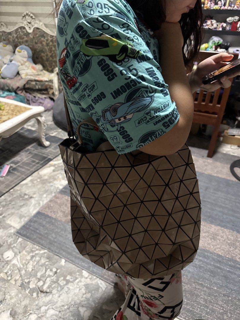 BAO BAO ISSEY MIYAKE Lucent Tote Bag (Category: Laptop Bags & Sleeves) located in Angeles City. Submitted by migs_font29 (Listing ID 1456815593, Image 2). Description: - Authentic Bao Bao Issey Miyake tote bag - Chic beige/tan color - Signature geometric design - Spacious interior with a zippered pocket - Genuine leather straps and accents - Ideal for everyday errands or travel .