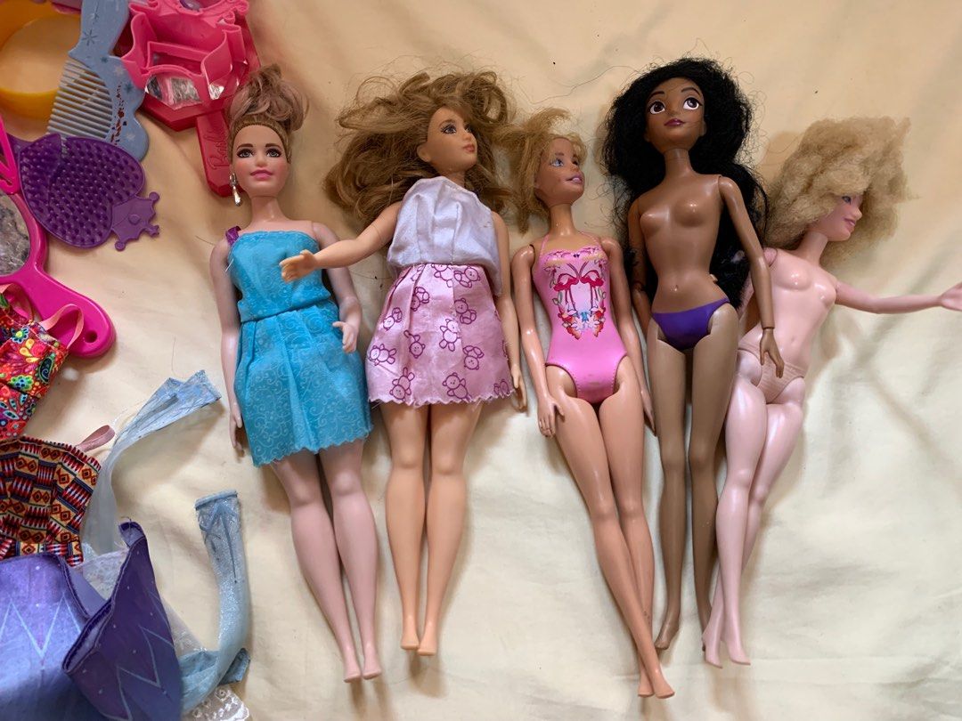 Barbie Dolls and Accessories Bundle (Category: Kids Toys) located in Manila. Submitted by elizabetharden123 (Listing ID 1456870342, Image 1). Description: - Bundle includes multiple Barbie dolls with different outfits and hairstyles. - Comes with a variety of fun accessories: clothes, shoes, brushes, mirrors, and more. - Great for sparking imaginative play and storytelling. - Items may be from different Barbie sets, all shown in the photos. - Per