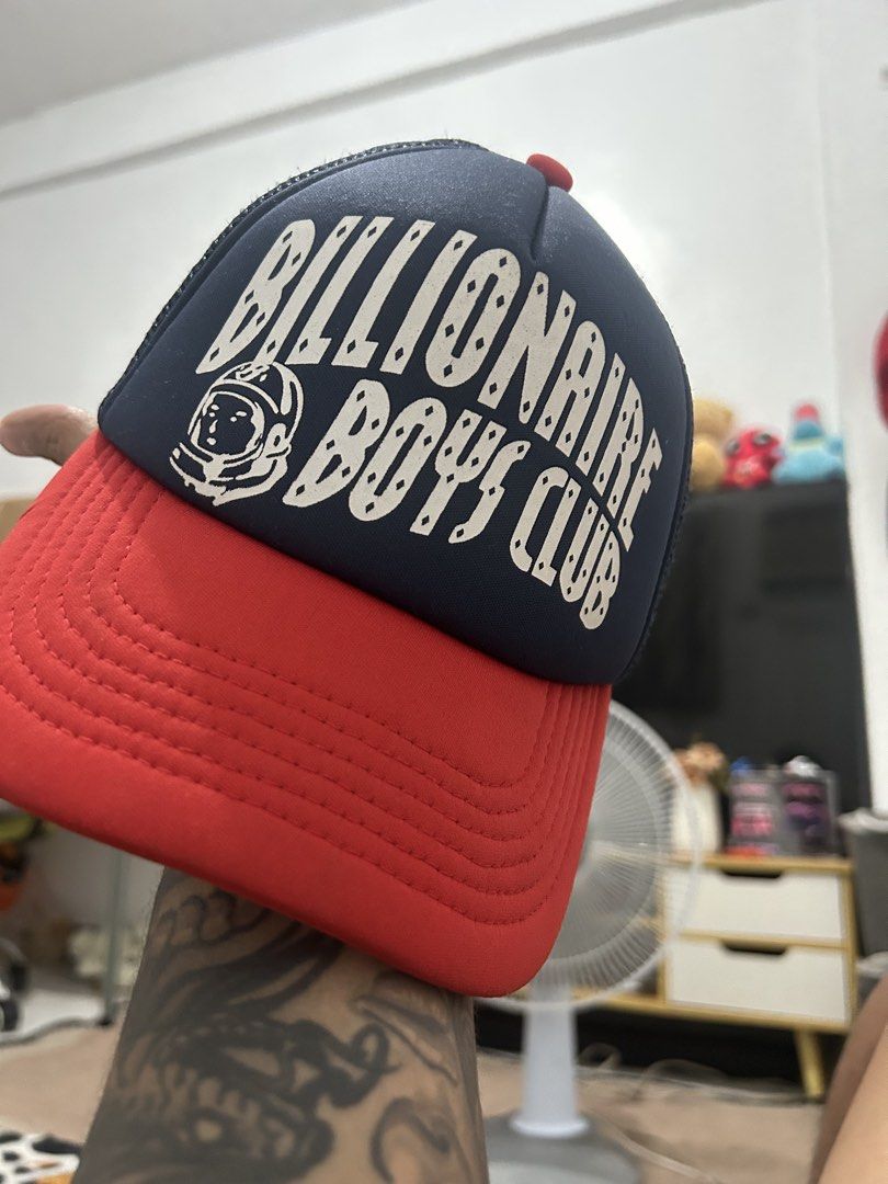 Billionaire Boys Club Trucker Cap (Category: Caps & Hats) located in Manila. Submitted by talaskidoo (Listing ID 1456901627, Image 1). Description: - Classic Billionaire Boys Club trucker cap - Features iconic astronaut logo and bold lettering - Navy blue and red colorway - Breathable mesh back - Adjustable strap for a custom fit - Ideal for any streetwear enthusiast.