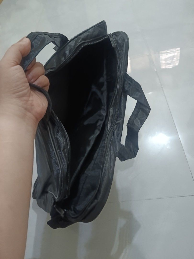 Black Laptop Bag with Shoulder Strap (Category: Laptop Bags & Sleeves) located in Valenzuela. Submitted by misssfashionn (Listing ID 1456817133, Image 3). Description: - Stylish black laptop bag - Comfortable handles and detachable shoulder strap - Eye-catching red accent line on the front - Secure zip-open main compartment - Ample space for laptop and accessories - Ideal for work, school, or daily commutes.