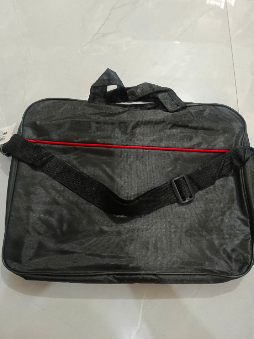 Black Laptop Bag with Shoulder Strap (Category: Laptop Bags & Sleeves) located in Valenzuela. Submitted by misssfashionn (Listing ID 1456817133, Image 1). Description: - Stylish black laptop bag - Comfortable handles and detachable shoulder strap - Eye-catching red accent line on the front - Secure zip-open main compartment - Ample space for laptop and accessories - Ideal for work, school, or daily commutes.