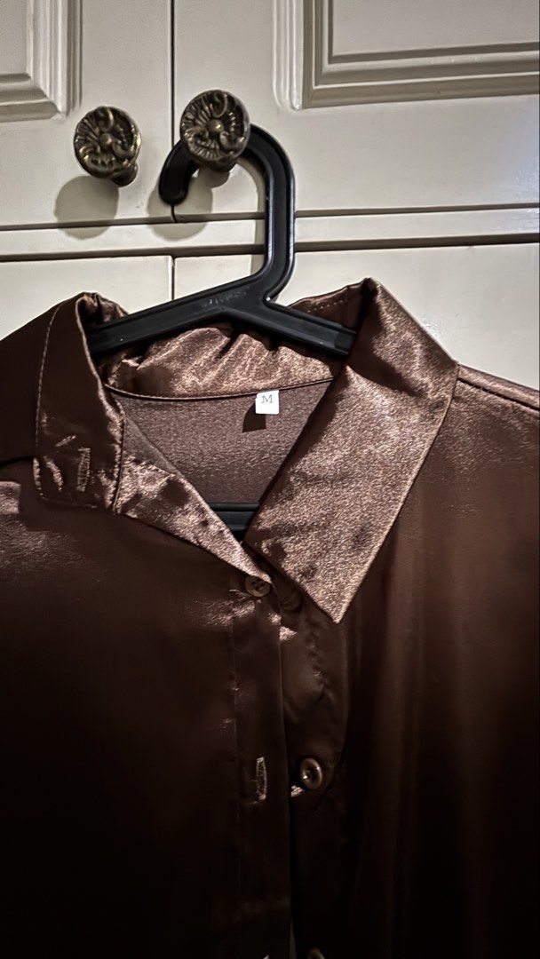 Brown Satin Button-Up Shirt (Category: Shirts) located in Manila. Submitted by daisiestuffph (Listing ID 1456868890, Image 2). Description: - Brown satin shirt - Button-up front - Collared neckline - Long sleeves with button cuffs - Features a beautiful sheen - Versatile for casual or formal wear - Easy to style Dimension Shoulder 17inch Sleeves 22inch Length 27incj Width 20inch.
