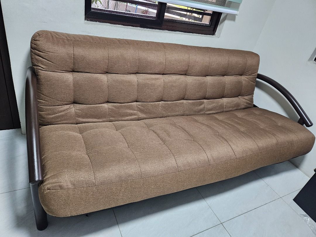 Brown Tufted Sofa Bed with Metal Frame (Category: Sofas) located in Tanza. Submitted by mama_1996sagi (Listing ID 1456828285, Image 1). Description: - Preloved sofa bed in an excellent condition. - Clean and no dents on metal frames. - Stylish brown sofa bed with elegant tufted design. - Durable dark metal frame. - Easily converts into a comfortable bed. - Ideal for small living spaces. - Provides comfortable seating for your living room..