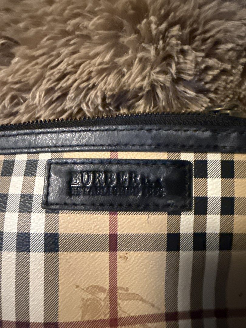 Burberry Nova Check Pouch with Leather Trim (Category: Others) located in Angeles City. Submitted by migs_font29 (Listing ID 1456893102, Image 2). Description: - Authentic Burberry Nova Check Pouch - Features black leather trim and zipper closure - Signature Burberry check pattern on interior lining - Small and compact, ideal for carrying essentials - Zipper operates smoothly.