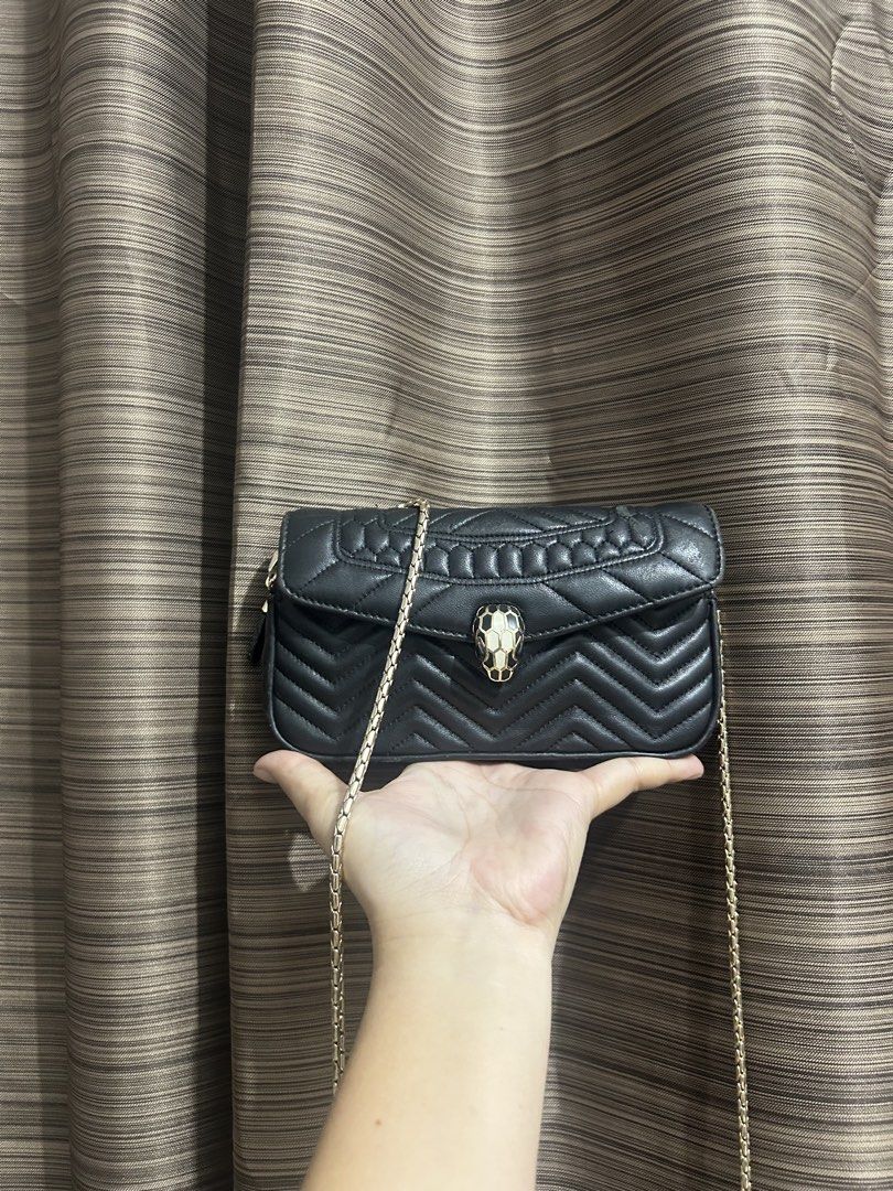 BVLGARI serpenti forever chain-strap Quilted Chevron Shoulder (Category: Luxury Bags & Wallets) located in Tacloban City. Submitted by houseofluxury.co (Listing ID 1456839552, Image 1). Description: - Authentic Bvlgari quilted chevron shoulder bag - Features a stylish gold chain strap - Unique snake head clasp with black and white details - Compact size, perfect for carrying essentials - Adds a chic and stylish touch to any outfit.