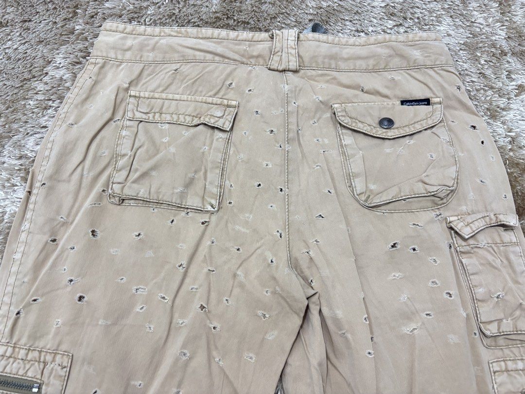 Calvin Klein Distressed Multipocket Baggy Beige Pants (Category: Jeans) located in Manila. Submitted by reymartreg23298 (Listing ID 1456945129, Image 3). Description: Waistline 34-35 Length 43.5 Thigh 12.5 Good condition Loc. Pasay City Metro Manila Courier. J&T FB : Reymart Regis.