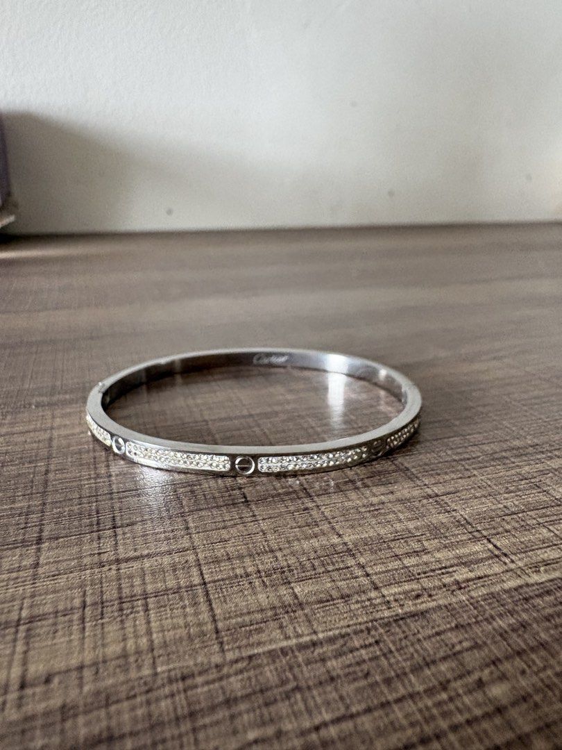 Cartier Love Bracelet with Crystals (Category: Bracelets) located in Manila. Submitted by samasamm (Listing ID 1456841701, Image 1). Description: - Not sure if original. (gifted to me lng with no box) - Silver-toned bracelet - Cartier engraving - Small crystals along the band - Classic screw motif detail - Ideal for stacking with other bracelets RFS: gifted to me but i dont wear bracelets.