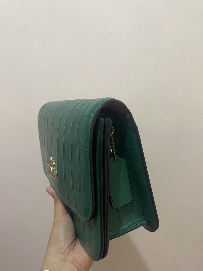 Coach Brynn Flap Crossbody Crocs Embossed (Category: Luxury Bags & Wallets) located in Taguig. Submitted by maeg_28 (Listing ID 1455928364, Image 3). Description: - Stylish green shoulder bag - Genuine croc-embossed leather - Elegant gold hardware and clasp closure - Plush tan suede interior - Adjustable strap for comfortable wear - Authentic Coach leather tag included - Versatile for day or evening use.