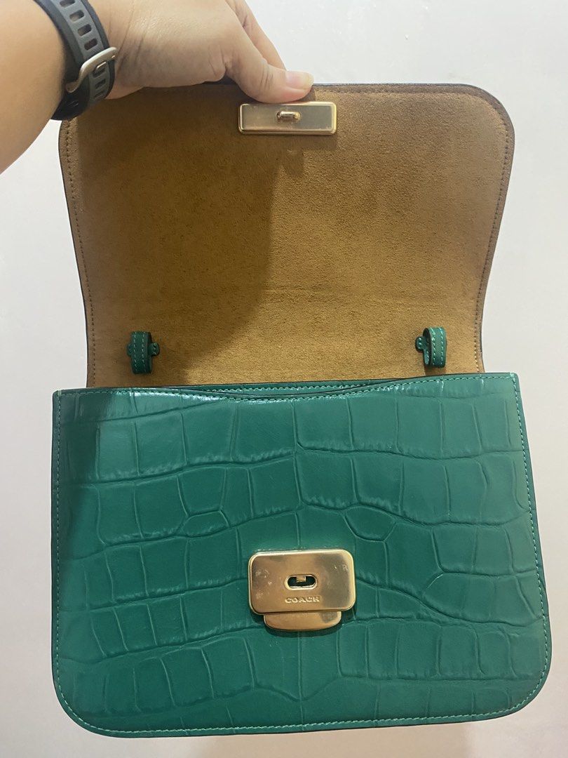 Coach Brynn Flap Crossbody Crocs Embossed (Category: Luxury Bags & Wallets) located in Taguig. Submitted by maeg_28 (Listing ID 1455928364, Image 2). Description: - Stylish green shoulder bag - Genuine croc-embossed leather - Elegant gold hardware and clasp closure - Plush tan suede interior - Adjustable strap for comfortable wear - Authentic Coach leather tag included - Versatile for day or evening use.