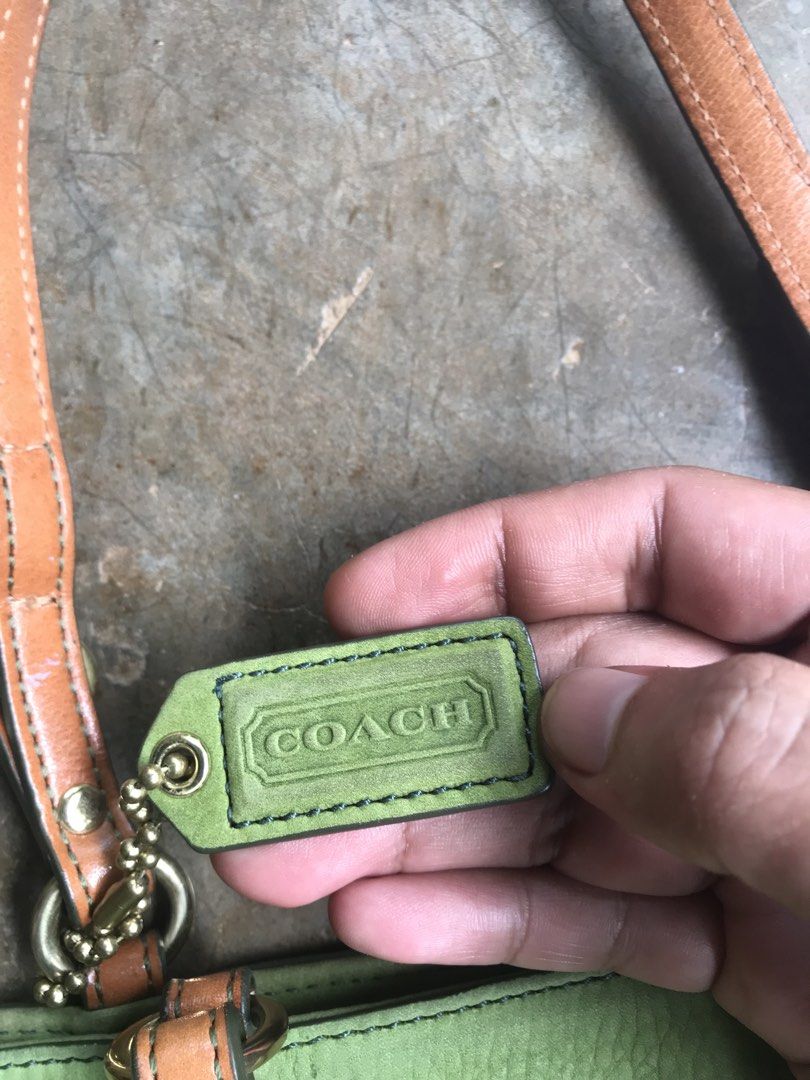 COACH CHELSEA TOTE (Category: Luxury Bags & Wallets) located in Aurora. Submitted by thrillthriftfinds123 (Listing ID 1456832013, Image 3). Description: The bag in the image is a Vintage Coach Chelsea Tote, specifically crafted in a green nubuck or suede leather finish. It features a prominent front slip pocket secured with a snap-button closure, dual leather shoulder straps with metallic buckle accents, and a matching green leather Coach hangtag