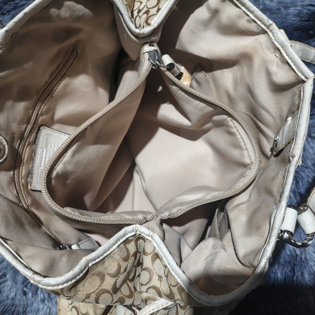 Coach Monogram Canvas & Leather Trim Tote Bag (Category: Luxury Bags & Wallets) located in Butuan. Submitted by luxestreet04 (Listing ID 1456825384, Image 3). Description: - Authentic Coach tote bag - Beige and brown monogram canvas - White leather trim with snakeskin accent stripe - Drawstring sides - Interior zippered pocket - Some signs of wear on leather trim and handles - Clean interior - Ideal for everyday use.