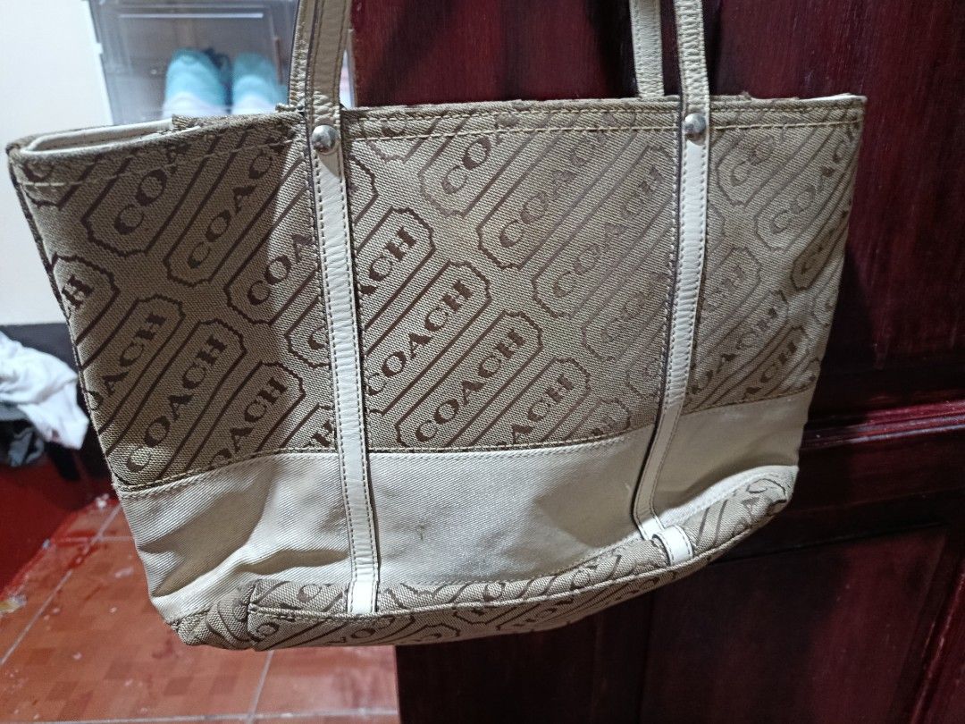 Coach Monogram Canvas Tote Bag (Category: Luxury Bags & Wallets) located in Manila. Submitted by empyuyubaron (Listing ID 1456879893, Image 1). Description: - Classic Coach tote bag - Signature brown and tan monogram pattern - Cream leather trim and handles - Spacious interior, great for everyday or travel - Shows some signs of wear on bottom corners and trim.