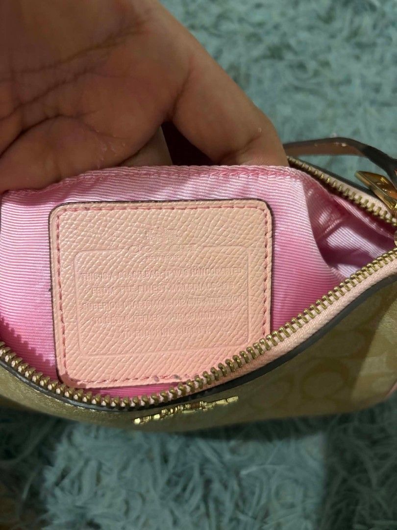 Coach Monogram Wristlet Pouch with Pink Trim (Category: Luxury Bags & Wallets) located in Daraga. Submitted by argarinang25024 (Listing ID 1456814257, Image 2). Description: -Coach wristlet pouch - Classic monogram print - Chic pink trim and strap - Secure zipper closure - Interior with pink lining - Gold hardware details - Ideal for carrying your daily essentials - No issue.