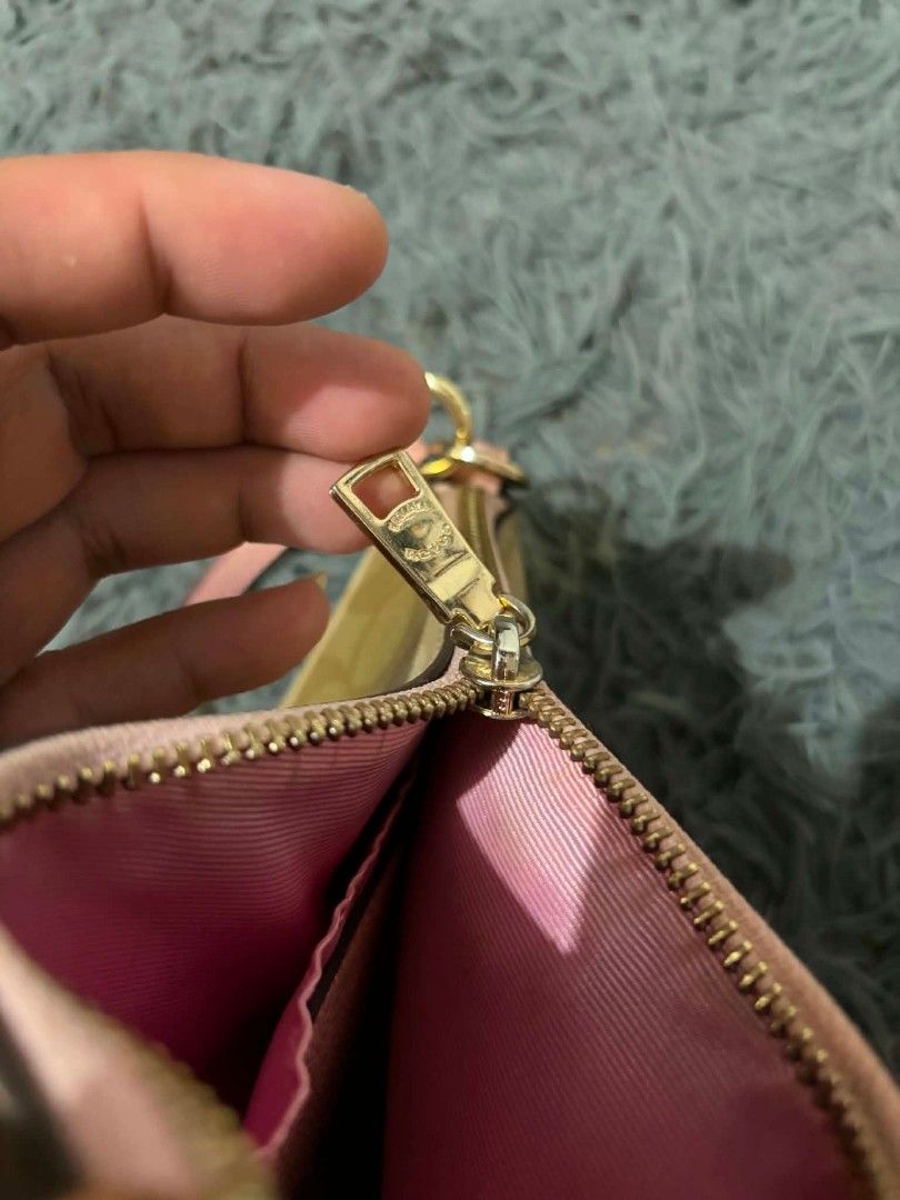 Coach Monogram Wristlet Pouch with Pink Trim (Category: Luxury Bags & Wallets) located in Daraga. Submitted by argarinang25024 (Listing ID 1456814257, Image 3). Description: -Coach wristlet pouch - Classic monogram print - Chic pink trim and strap - Secure zipper closure - Interior with pink lining - Gold hardware details - Ideal for carrying your daily essentials - No issue.