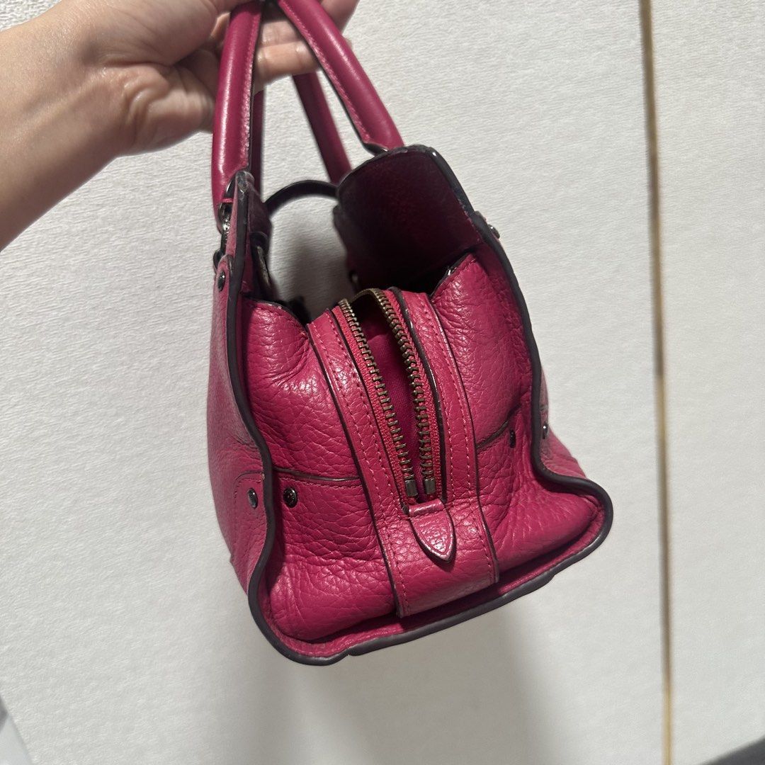 Coach Pebble Leather Handbag - Pink (Category: Luxury Bags & Wallets) located in Marikina City. Submitted by bry_lei26 (Listing ID 1456908521, Image 3). Description: - Genuine pink pebbled leather Coach handbag - Classic top handles - Secure turn-lock closure at the front - Spacious zippered main compartment - Interior pockets for organization - Includes original Coach hangtag - Ideal for everyday use -rfs: decluttering with minimal signs of usag
