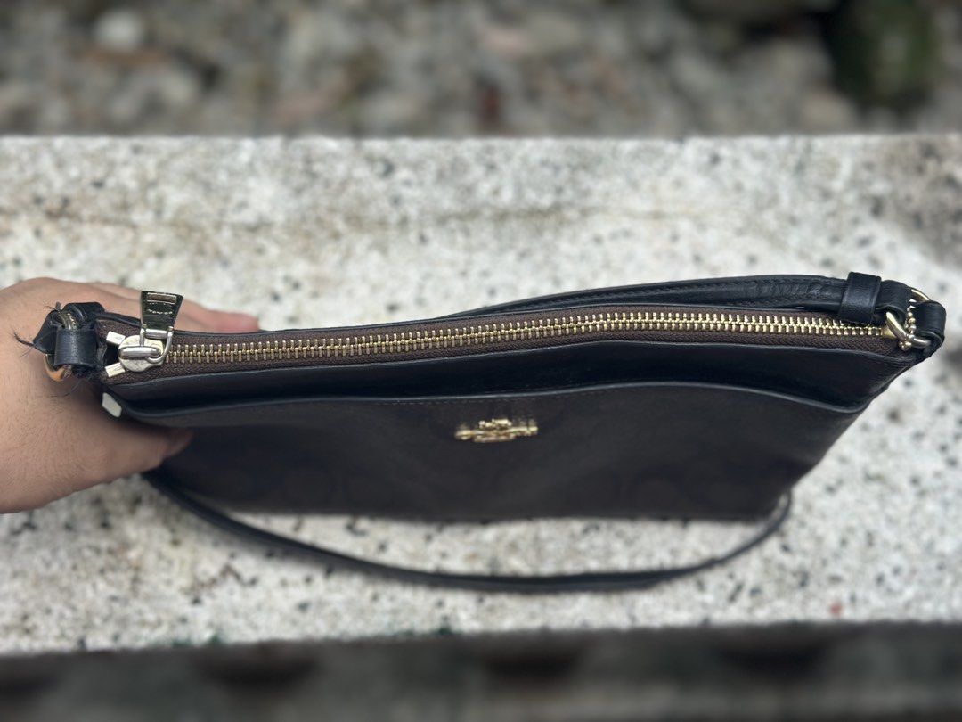 Coach purse (Category: Luxury Bags & Wallets) located in Pasig City. Submitted by lancer501 (Listing ID 1456814294, Image 2). Description: - Brand: Coach - Type: Vanity Bag - Color: Brown signature pattern - Condition: Great, pre-loved - Features: Compact and stylish design - Perfect for everyday use -Comes with coach envelope addon -creed is damaged by age -Shipping shouldered by buyer.