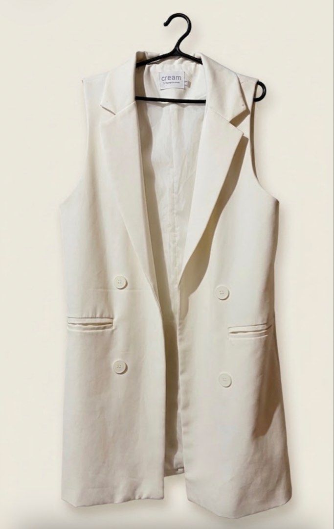 Cream Sleeveless Double-Breasted Blazer (Category: Coats, Jackets and Outerwear) located in Quezon City. Submitted by dearchelly777 (Listing ID 1456836305, Image 1). Description: - Cream sleeveless blazer - Korean made - Double-breasted style with two buttons - Two front pockets - Ideal for layering over tops or dresses - Versatile for smart casual or office wear - Bought 1500 .